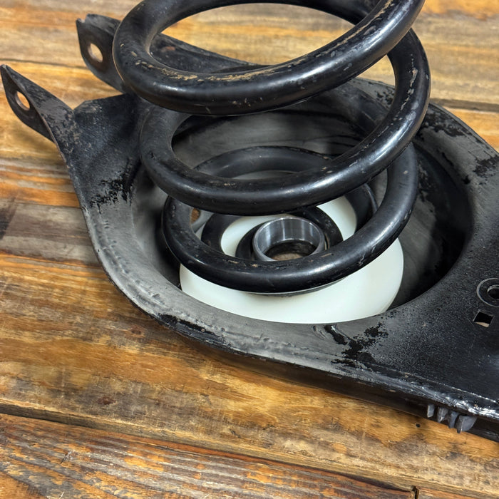 Close-up of a mechanical component with springs on a wooden surface