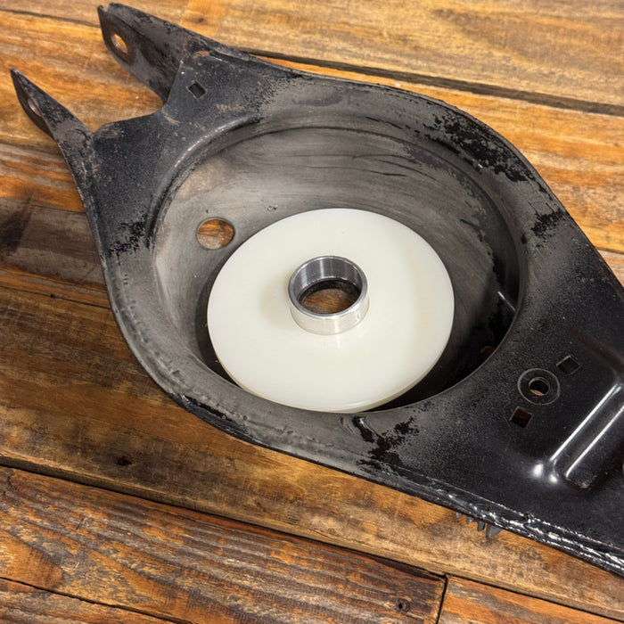 Mechanical component with a white wheel on a wooden surface